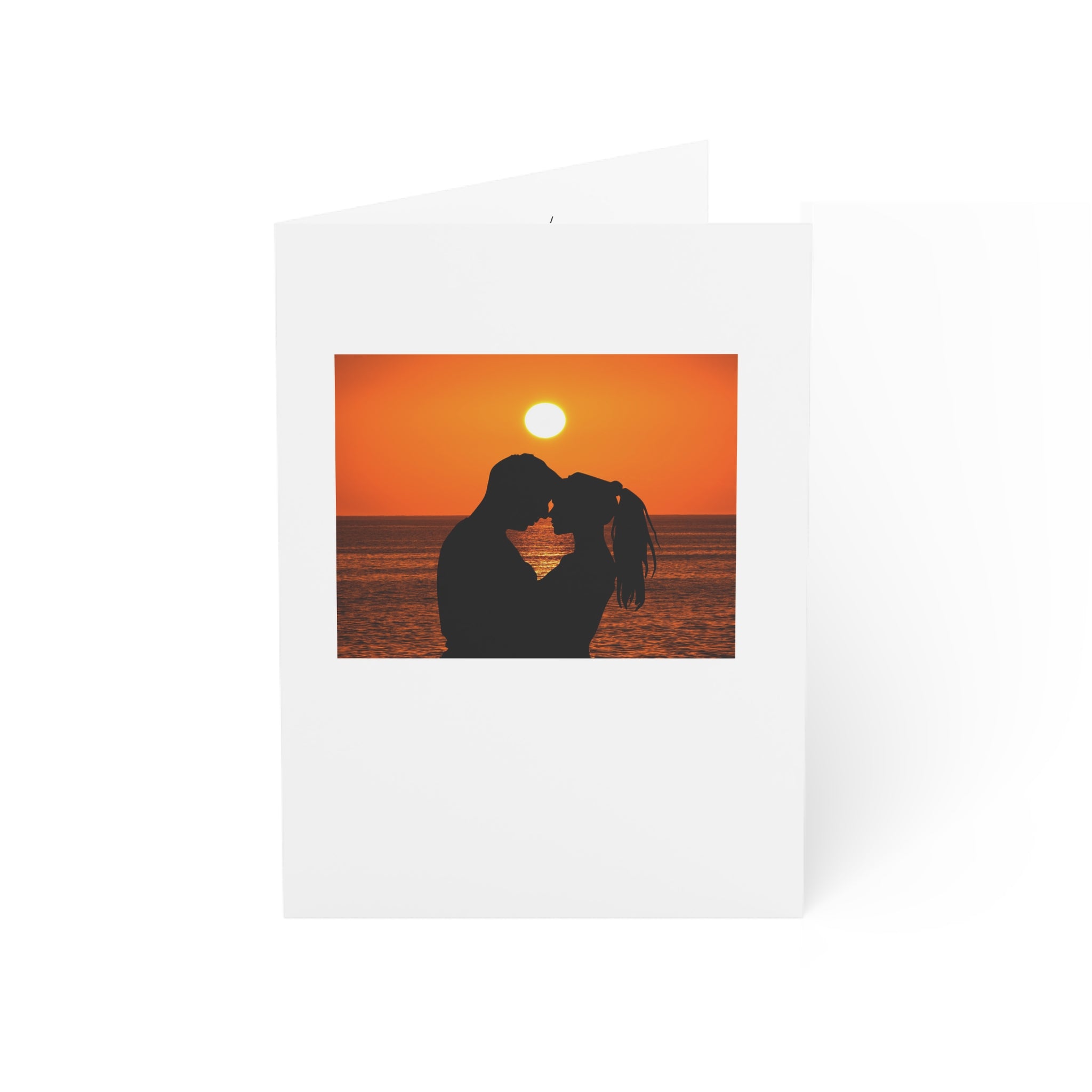 Greeting Cards - Couple on a beach at sunset